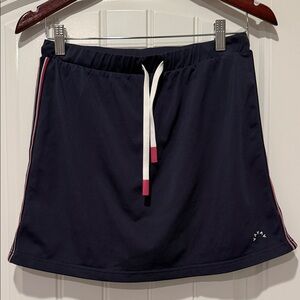 Varley Patrick Navy mid rise skort/skirt with red/white  Accents. Size M